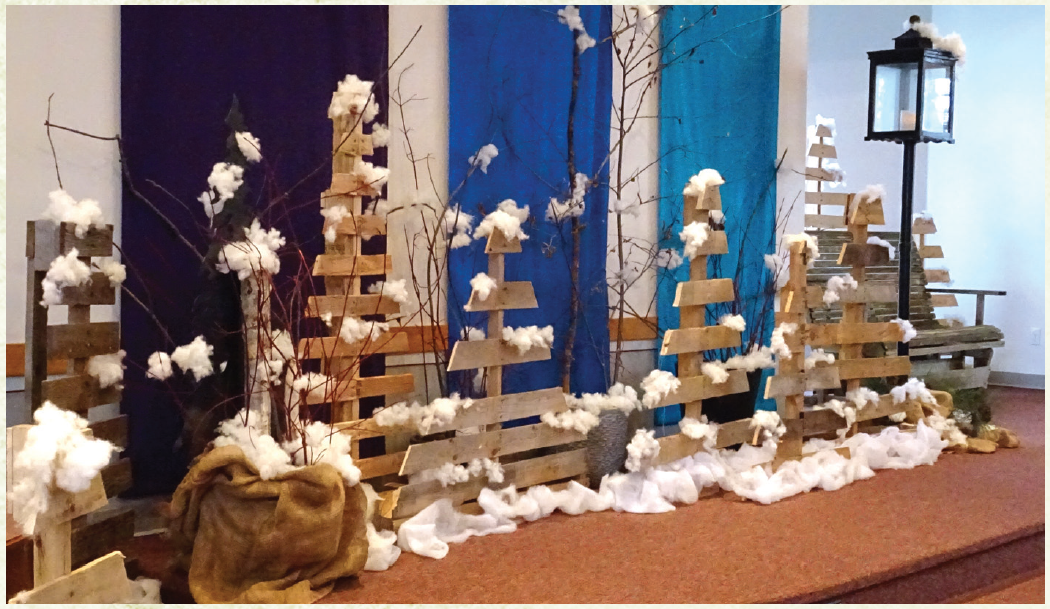 Snow covered wooden pallets meant to look like trees