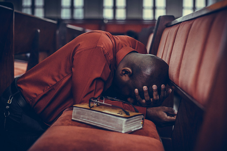 Person kneeling in prayer