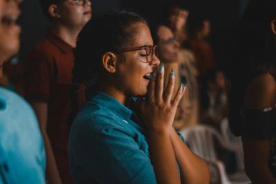 Girl with hands together in praise