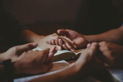 Holding hands in prayer