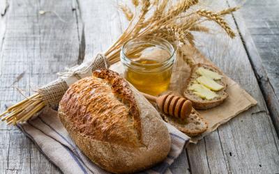 Bundle of weat, loaf of bread, honey jar