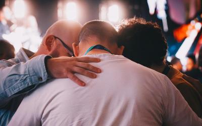 Group praying over one another