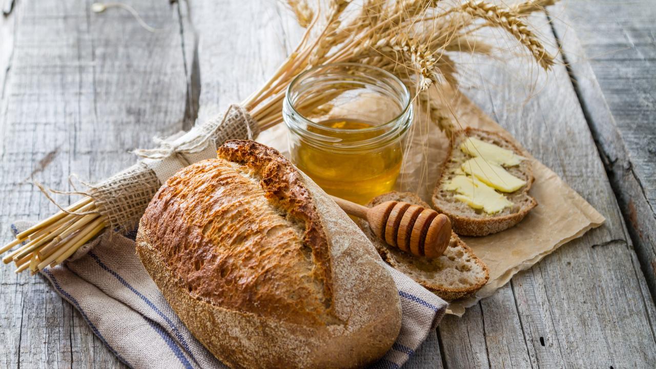 Bundle of weat, loaf of bread, honey jar