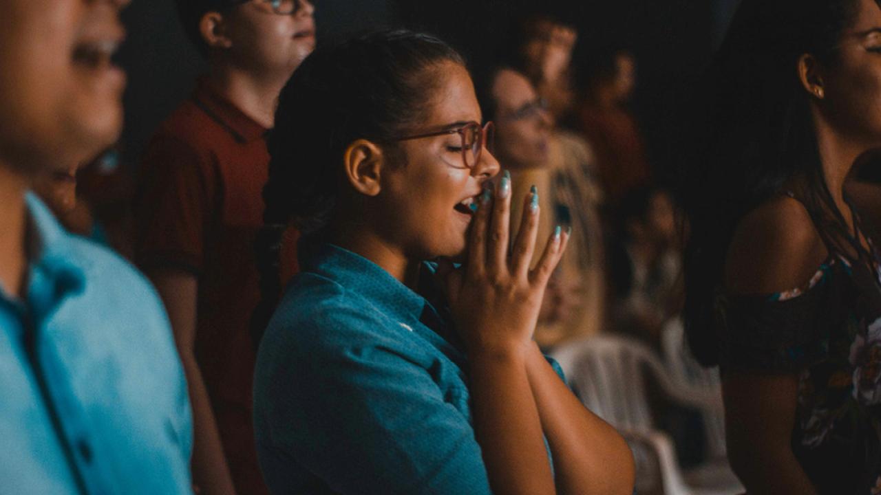 Girl with hands together in praise