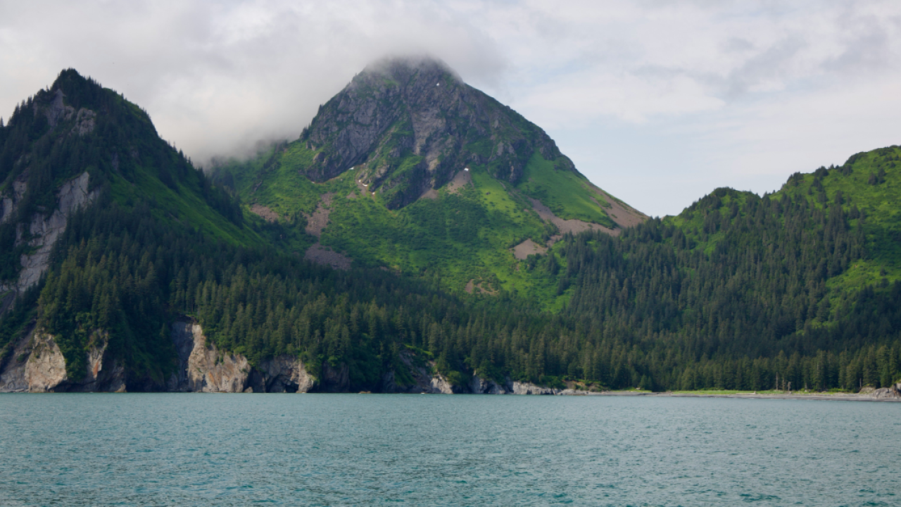 Lake, mountains, clouds covering mountains