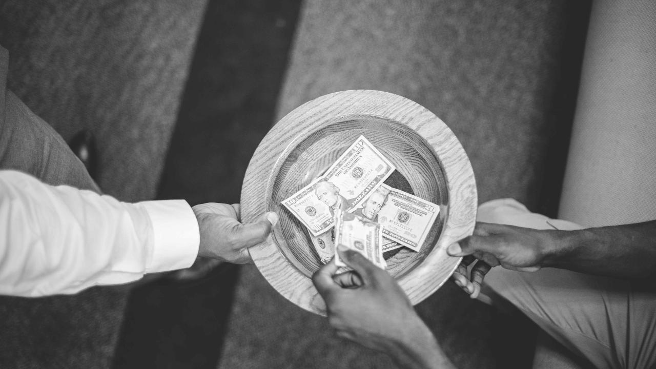 Overhead shot of the offering plate being passed