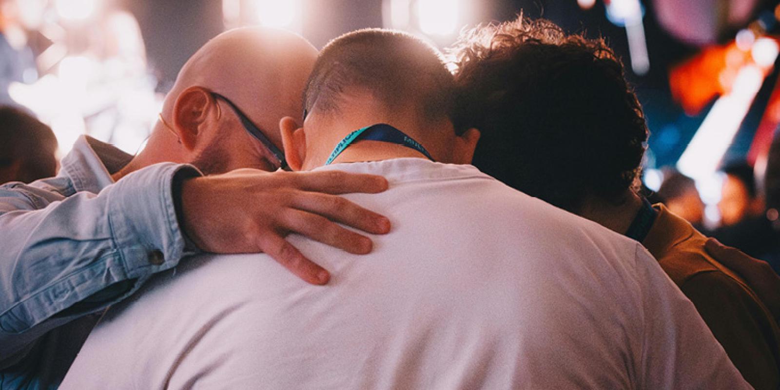 Group praying over one another
