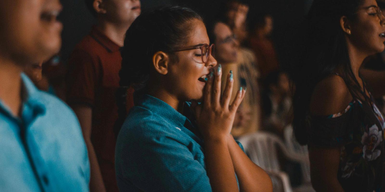 Girl with hands together in praise