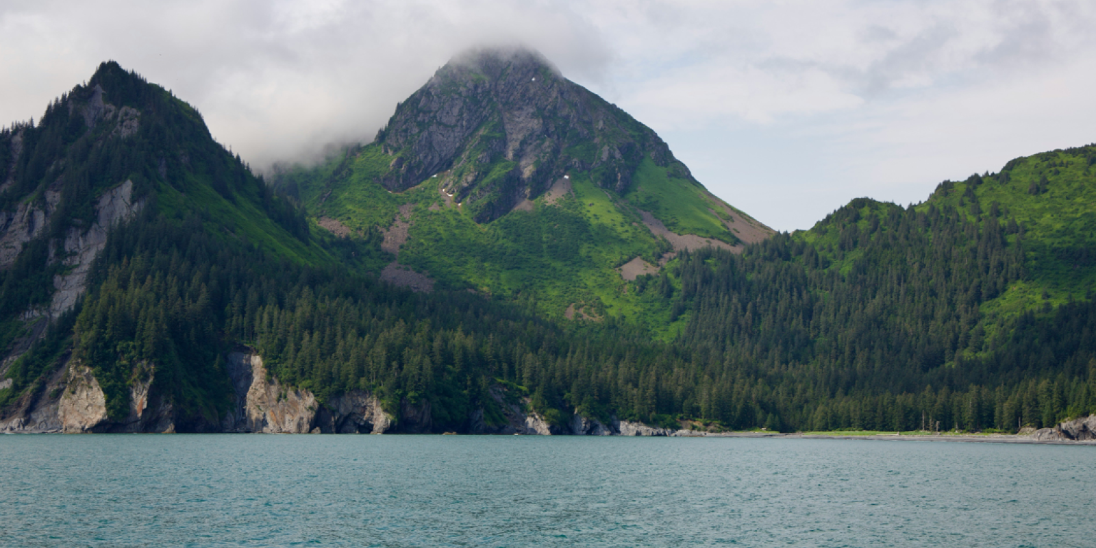 Lake, mountains, clouds covering mountains