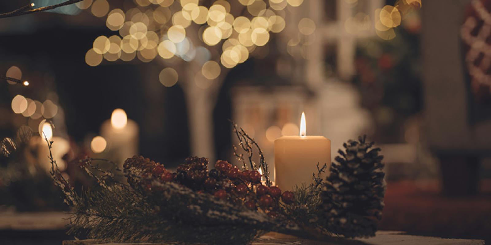Christmas scene with candle and a pinecone