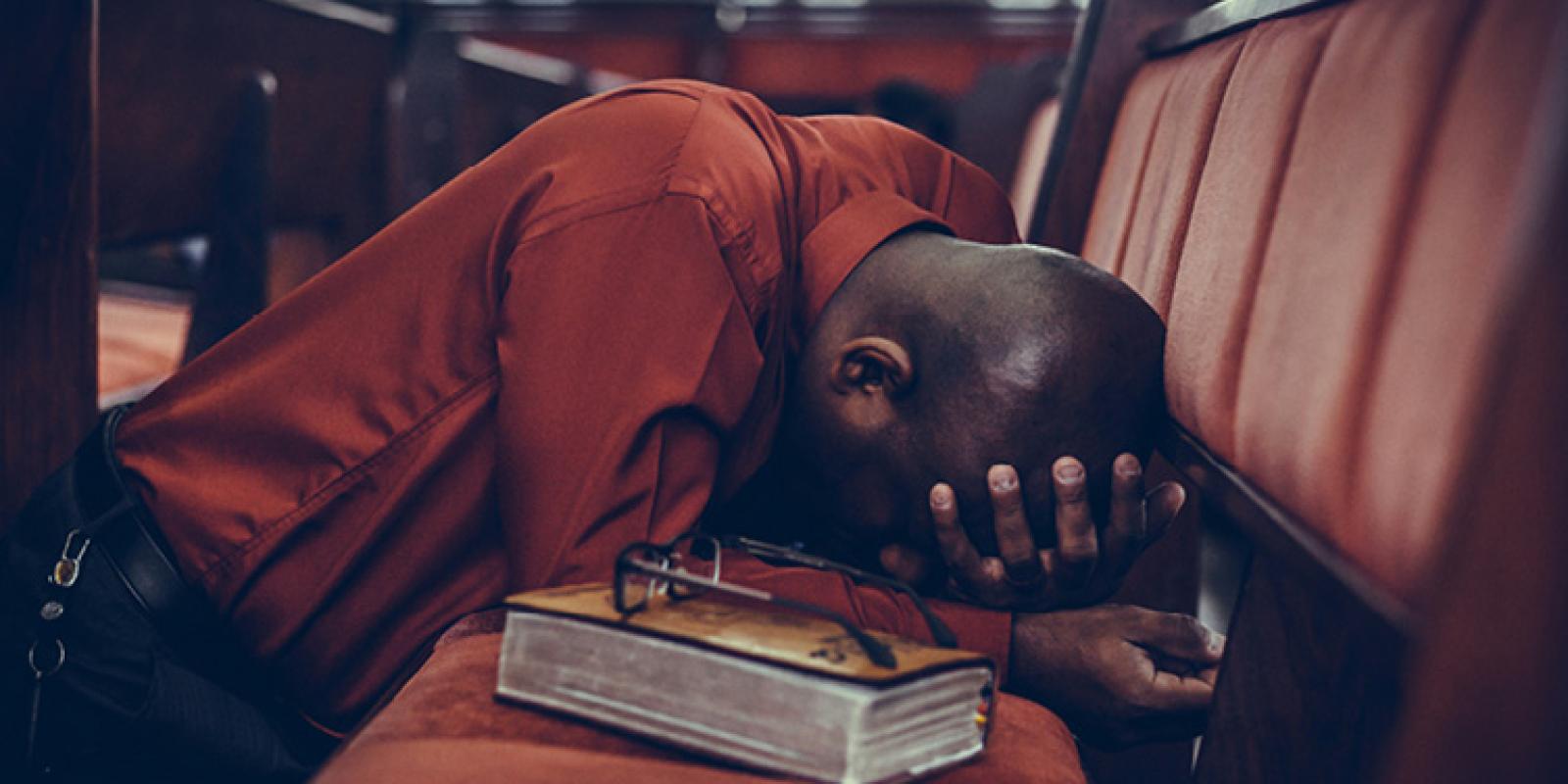 Person kneeling in prayer