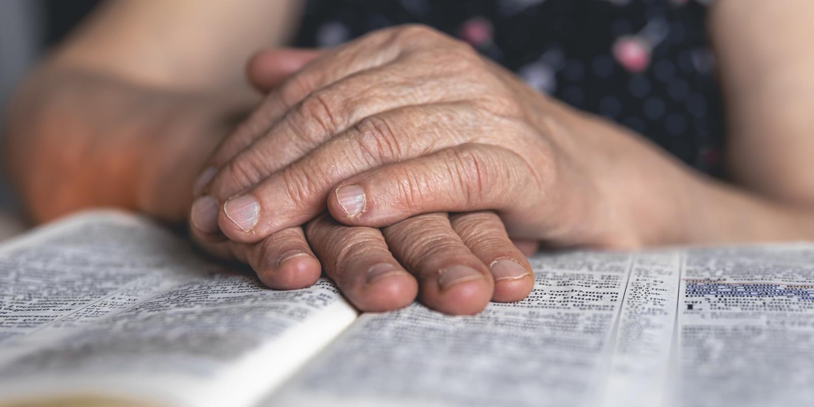 old-woman-reads-bible-hands-close-up