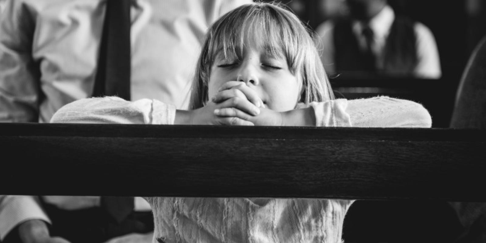 Child praying in church